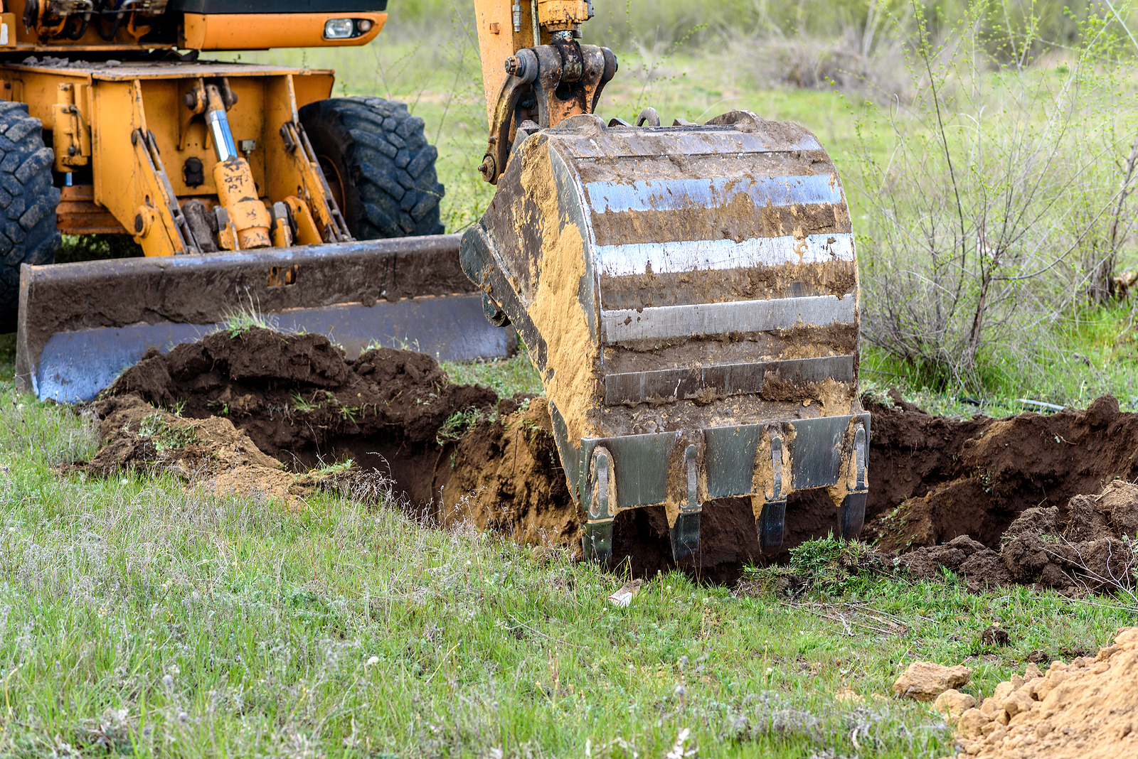 rubber duck digger - Yellow-Excavator-On-A-Construction-Site